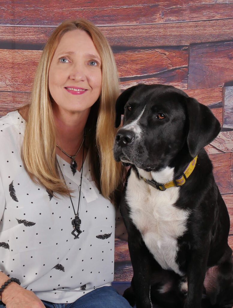 Cindie Carter of Walks and Wags with black dog