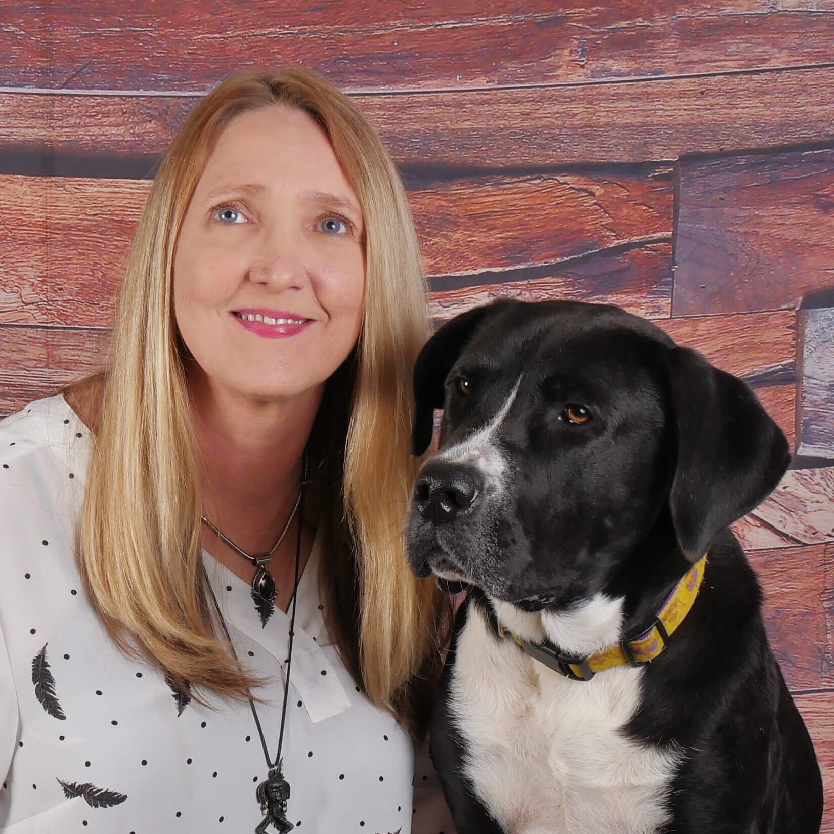 Cindie Carter of Walks and Wags with black dog